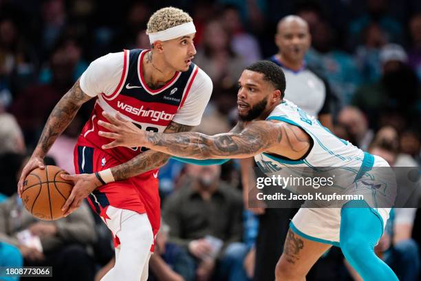 Miles Bridges of the Charlotte Hornets guards Kyle Kuzma of the Washington Wizards in the third quarter during their game at Spectrum Center on...