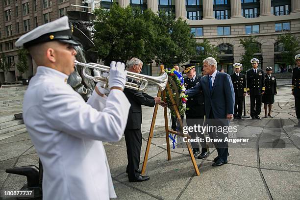 Secretary of Defense Chuck Hagel, right, and Chairman of the Joint Chiefs of Staff Gen. Martin Dempsey, left, lay a wreath in honor of the Navy Yard...