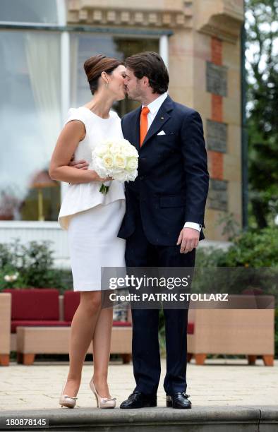 Prince Felix of Luxembourg and German student Claire Lademacher kiss under the rain as they pose for pictures after their Civil Wedding Ceremony at...