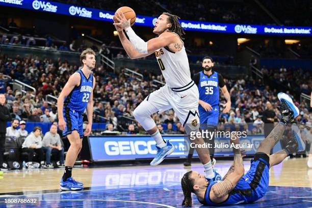 Aaron Gordon of the Denver Nuggets shoots the ball after drawing the foul from Cole Anthony of the Orlando Magic in the first half of a game at Amway...