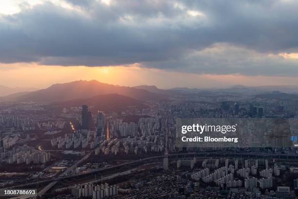 Commercial and residential buildings seen from the rooftop of the Lotte Corp. World Tower at sunset in Seoul, South Korea, on Tuesday, Nov. 28, 2023....