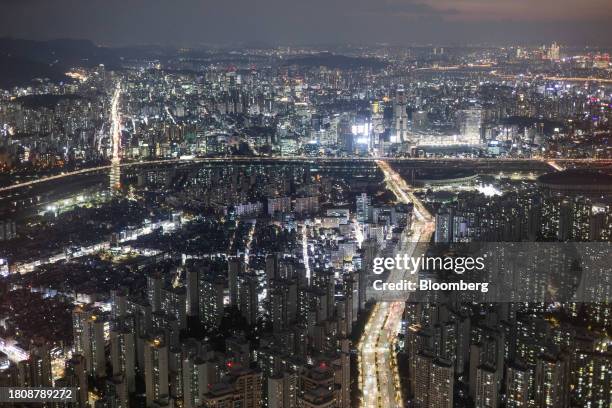 Illuminated commercial and residential buildings seen from the Lotte Corp. World Tower in Seoul, South Korea, on Tuesday, Nov. 28, 2023. South Korea...