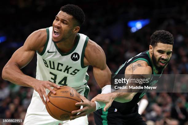 Jayson Tatum of the Boston Celtics defends Giannis Antetokounmpo of the Milwaukee Bucks during the second half at TD Garden on November 22, 2023 in...