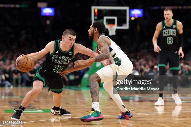 Payton Pritchard of the Boston Celtics drives to the basket past Cameron Payne of the Milwaukee Bucks during the second half at TD Garden on November...