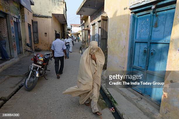 Kawal, INDIA SEPTEMBER 13: A Muslim woman in a burkha walks through the market in Kawal village, Muzaffarnagar district, Bihar.