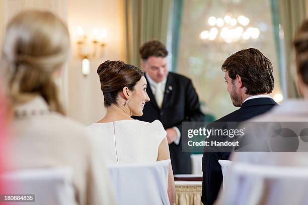 In this handout image provided by the Grand-Ducal Court of Luxembourg, Claire Lademacher and Prince Felix Of Luxembourg exchange a look as they...