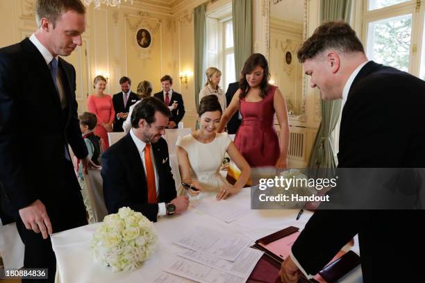 In this handout image provided by the Grand-Ducal Court of Luxembourg, Prince Felix Of Luxembourg and Claire Lademacher sign their civil wedding...