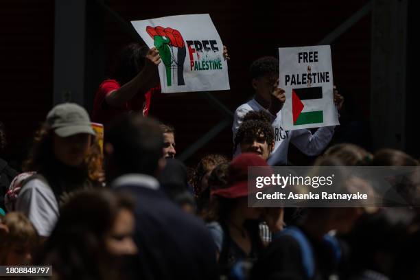 Protesters march holding placards and chanting slogans on November 23, 2023 in Melbourne, Australia. Organised by School Students For Palestine, the...