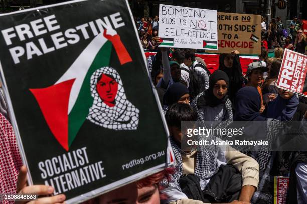 Protesters hold Free Palestine placards on November 23, 2023 in Melbourne, Australia. Organised by School Students For Palestine, the call for action...
