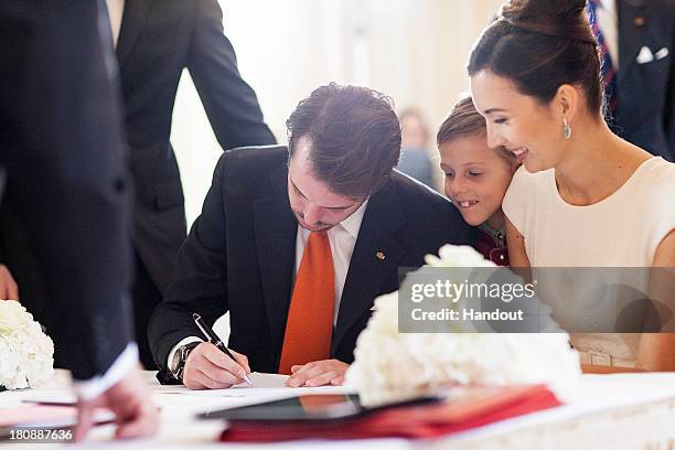 In this handout image provided by the Grand-Ducal Court of Luxembourg, Prince Felix Of Luxembourg signs his civil wedding contract in front of his...