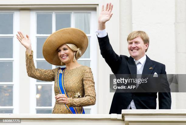 Dutch King Willem-Alexander and Queen Maxima wave to the crowd from the balcony of Palace Noordeinde in the Hague, the Netherlands, on September 17...