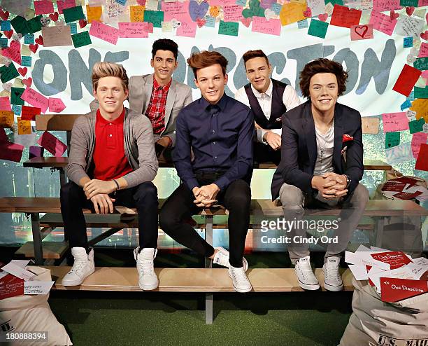 In honor of National Love Note Day, One Direction fans leave notes beside the band's wax figures at Madame Tussauds New York on September 17, 2013 in...