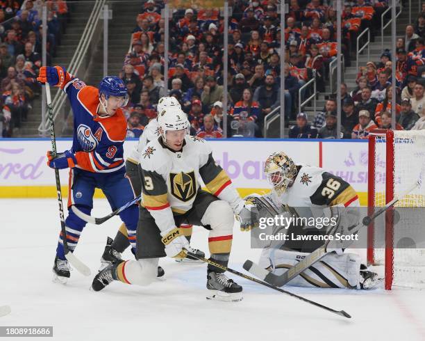 Goaltender Logan Thompson and Brayden McNabb of the Las Vegas Golden Knights battles Ryan Nugent-Hopkins of the Edmonton Oilers in the third period...