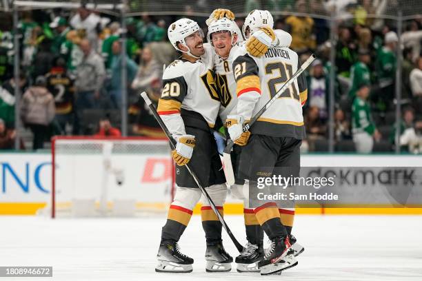 Chandler Stephenson and Brett Howden of the Vegas Golden Knights congratulate Jack Eichel after he scored the game winning goal in overtime to defeat...
