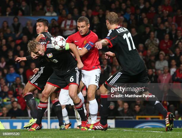 Nemanja Vidic of Manchester United in action with Simon Rolfes and Stefan Kiessling of Bayer Leverkusen during the UEFA Champions League Group A...