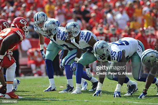 Players DeVonte Holloman, Orlando Scandrick and Edgar Jones of the Dallas Cowboys gets set to rush on a punt against the Kansas City Chiefs during...