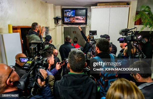 Relative of Ahmad Salaima, a 14-year-old Palestinian about to be released under an extended truce deal, points to a screen displaying security camera...