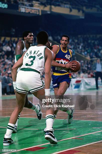 Wayne Cooper of the Denver Nuggets drives to the basket against Dennis Johnson and Robert Parish of the Boston Celtics during a game circa 1986 at...