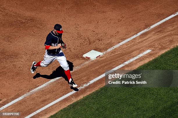 Left fielder Bryce Harper of the Washington Nationals jumps over the first baseline after the top of the fifth inning ended against the Atlanta...