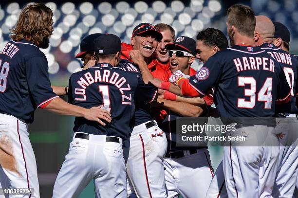 Denard Span of the Washington Nationals is mobbed by teammates after his hit drove in the game-winning run against the Atlanta Braves in the ninth...
