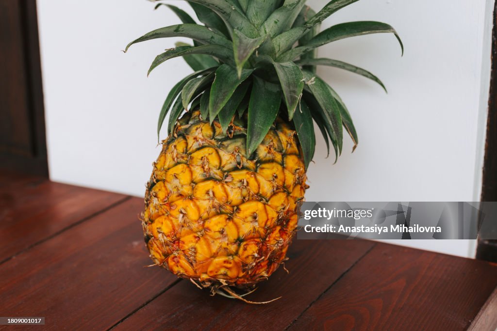 Pineapple close-up on a white wall background