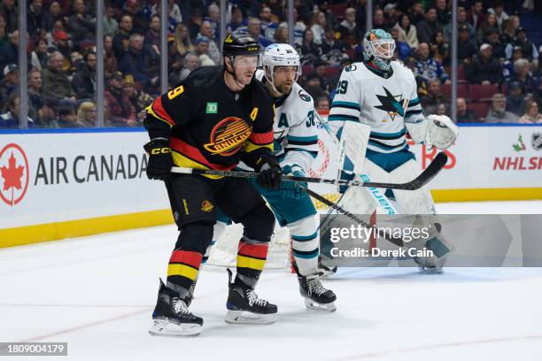 Mario Ferraro of the San Jose Sharks defends against J.T. Miller of the Vancouver Canucks during the first period of their NHL game at Rogers Arena...