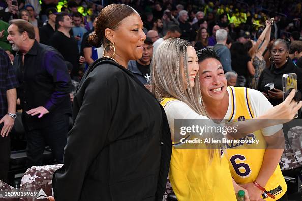 Queen Latifah poses for a selfie with fans prior to a basketball game