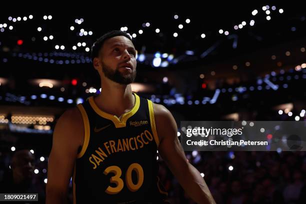 Stephen Curry of the Golden State Warriors stands on the court before the NBA game against the Phoenix Suns at Footprint Center on November 22, 2023...