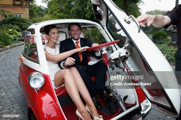 Prince Felix Of Luxembourg and Princess Claire of Luxembourg depart in the Italian-designed BMW Isetta 300 microcar after their Civil Wedding...