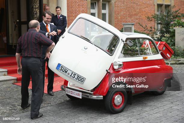 Prince Felix Of Luxembourg and Princess Claire of Luxembourg depart in the Italian-designed BMW Isetta 300 microcar after their Civil Wedding...