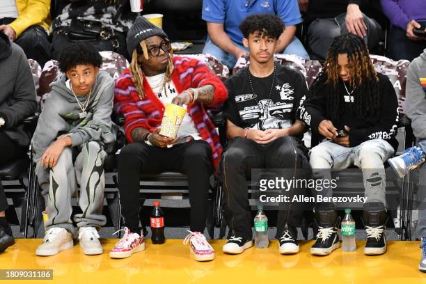Kameron Carter, Lil Wayne and Dwayne Carter III attend a basketball game between the Los Angeles Lakers and the Dallas Mavericks at Crypto.com Arena...