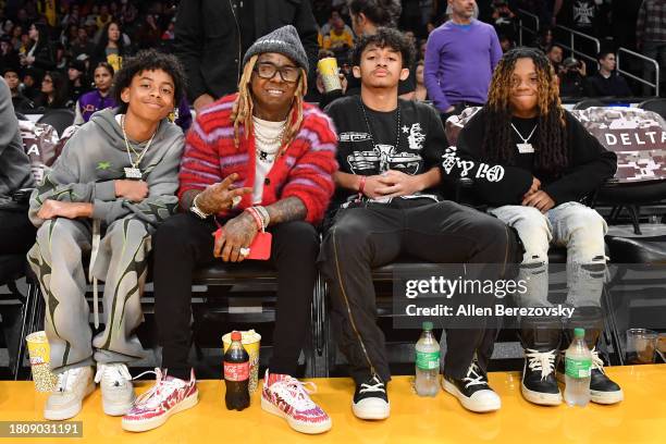 Kameron Carter, Lil Wayne, Dwayne Carter III and Neal Carter attend a basketball game between the Los Angeles Lakers and the Dallas Mavericks at...