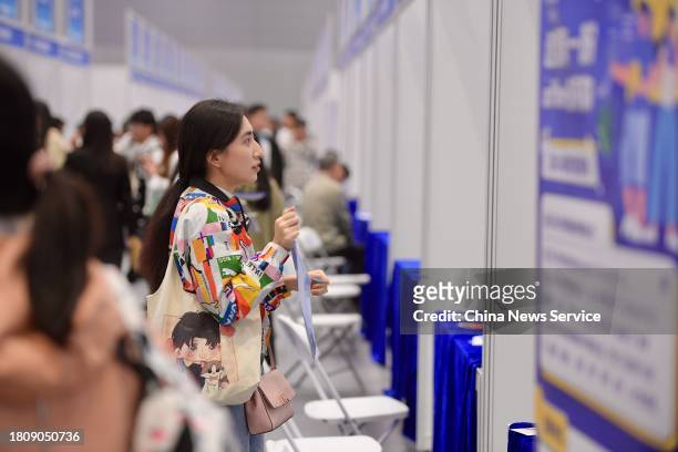 Job applicants look for employment opportunities at Guangdong-Hong Kong-Macao Greater Bay Area job fair on November 22, 2023 in Shenzhen, Guangdong...