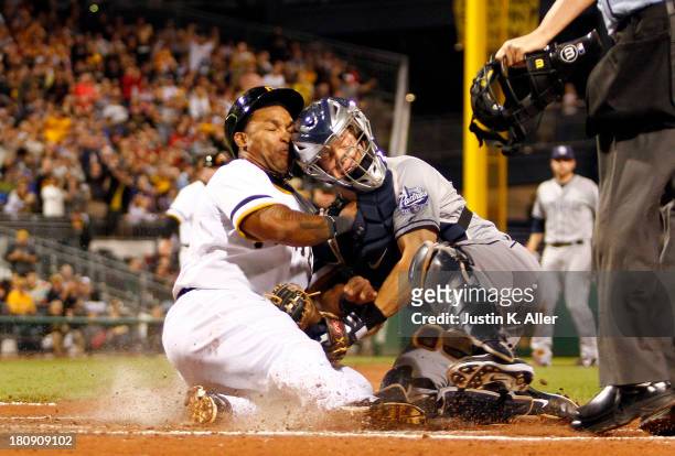 Nick Hundley of the San Diego Padres tags out Marlon Byrd of the Pittsburgh Pirates in the third inning during the game on September 17, 2013 at PNC...