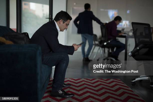 Representative Samuel Pérez looks at his phone before holding a meeting with elected representatives of the Semilla Movement party in Guatemala City...