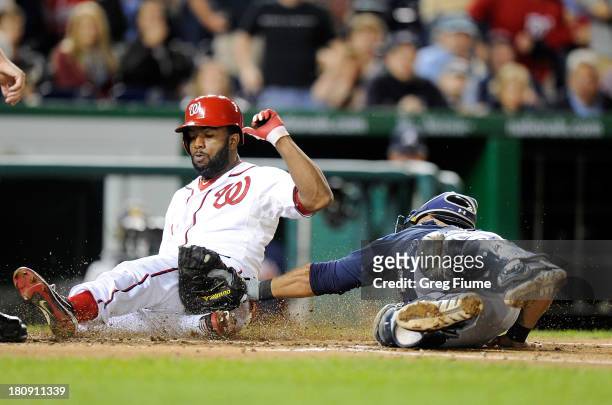 Denard Span of the Washington Nationals is tagged out at home plate in the third inning by Gerald Laird of the Atlanta Braves at Nationals Park on...