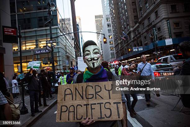 An Occupy Wall Street protester participates in a march from the United Nations building to Bryant Park on September 17, 2013 in New York City. The...