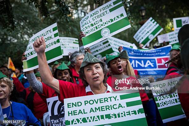 Occupy Wall Street protesters attend a rally outside the United Nations building prior to marching to Bryant Park on September 17, 2013 in New York...