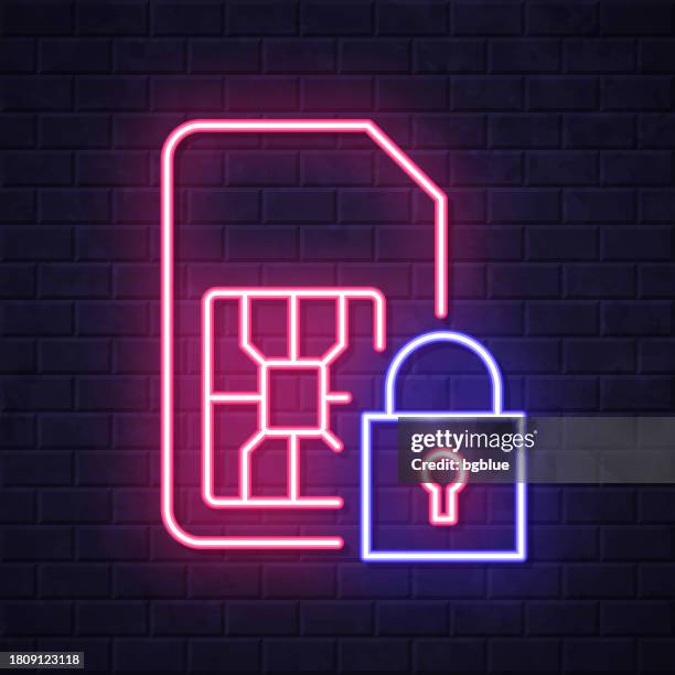 sim card with padlock. glowing neon icon on brick wall background - red sim card stock illustrations