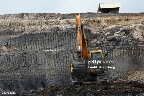 An excavator operates at the PT Exploitasi Energi Indonesia open pit coal mine in Palaran, East Kalimantan province, Indonesia, on Friday, Sept. 13,...