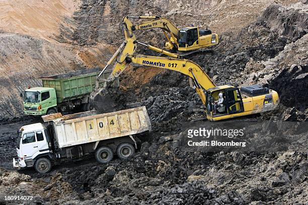 Komatsu Ltd. Excavators load trucks at the PT Exploitasi Energi Indonesia open pit coal mine in Palaran, East Kalimantan province, Indonesia, on...