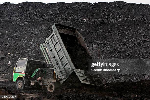 Truck unloads coal at a storage area of the PT Exploitasi Energi Indonesia open pit coal mine in Palaran, East Kalimantan province, Indonesia, on...