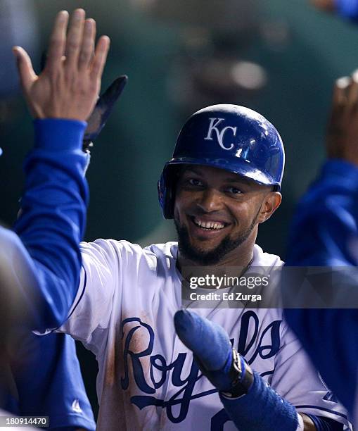 Emilio Bonifacio of the Kansas City Royals is congratulated by teammates after scoring on a sacrifice fly by Salvador Perez , the third inning during...