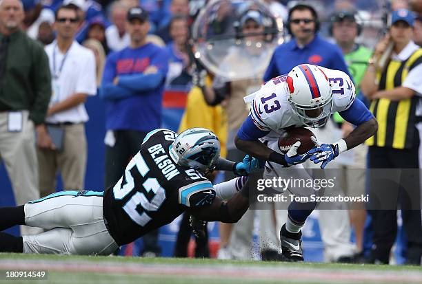 Stevie Johnson of the Buffalo Bills is tackled during NFL game action by Jon Beason of the Carolina Panthers at Ralph Wilson Stadium on September 15,...