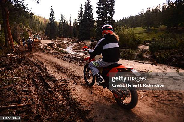 Off road bikers make their way across Colorado Road 43 as they head away from the town of Glen Haven, CO on September 17, 2013. The small mountain...