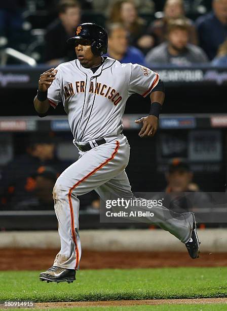 Tony Abreu of the San Francisco Giants scores a run in the eighth inning against the New York Mets during their game at Citi Field on September 17,...
