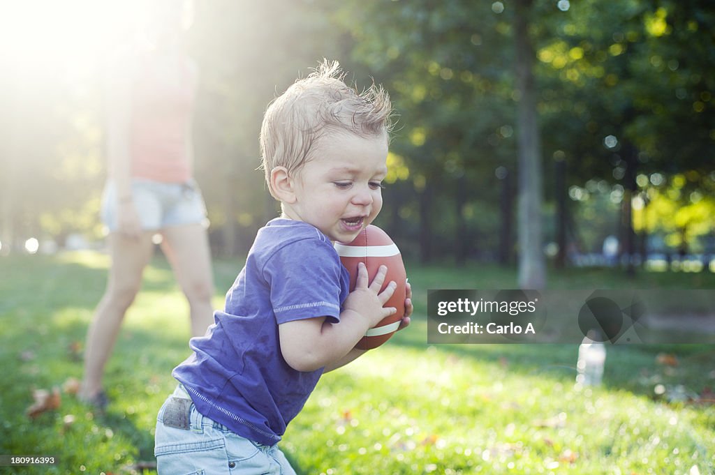 Baby with rugby ball