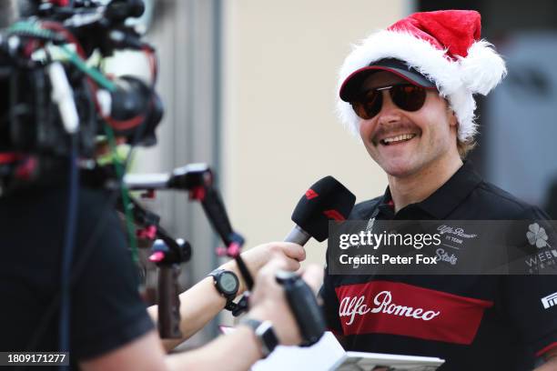 Valtteri Bottas of Finland and Alfa Romeo F1 talks to the media in the Paddock during previews ahead of the F1 Grand Prix of Abu Dhabi at Yas Marina...