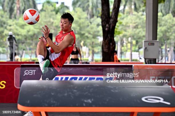 China's Zhang Jun Ming returns the ball against Britain's Andrew Henderson during the men's singles group stage match on the first day of the World...