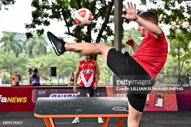Britain's Andrew Henderson serves the ball against China's Zhang Jun Ming during the men's singles group stage match on the first day of the World...